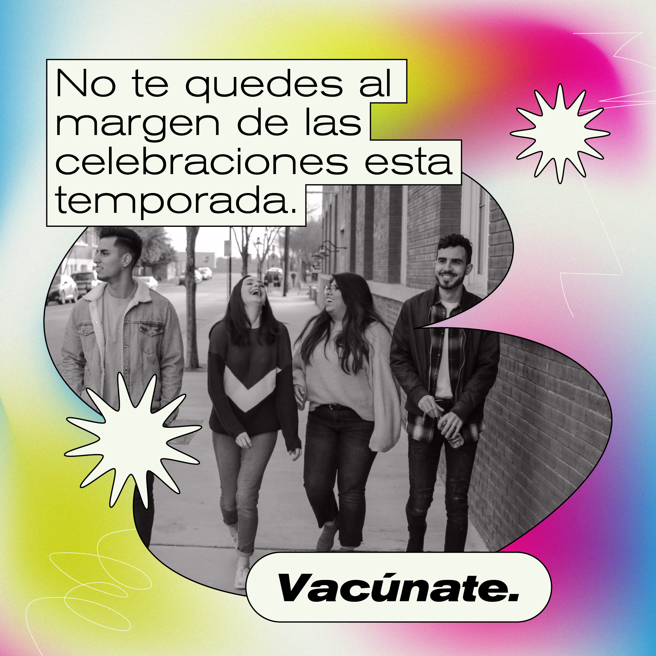 Young people laugh walking along a street together