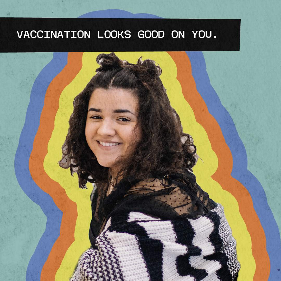 Young woman smiling with a blanket wrapped around her shoulders. Message says "Vaccination looks good on you."