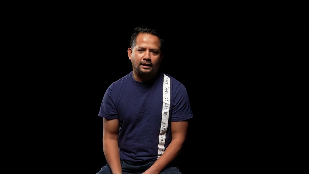 An Asian man is speaking. 