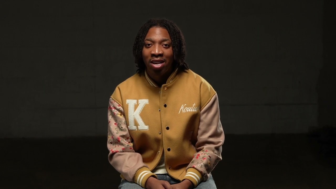 Tezzaree El-Amin Champion sits and speaks to the camera 