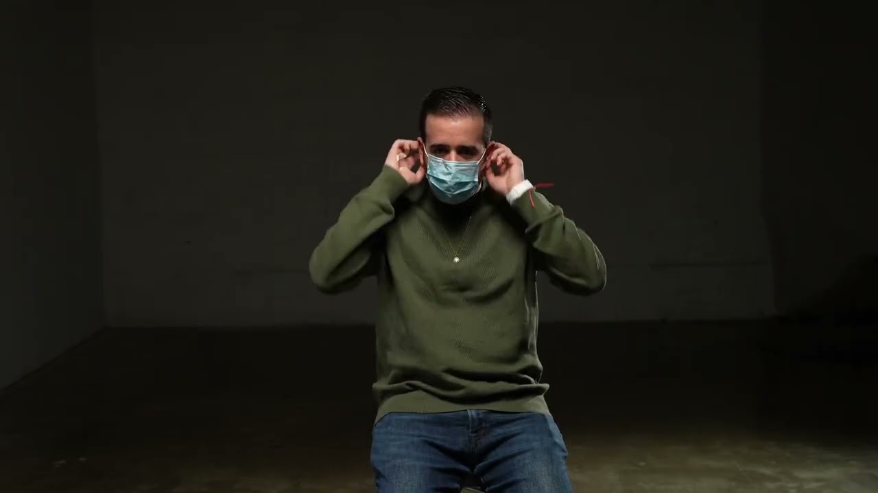 A Latinx man on a black background