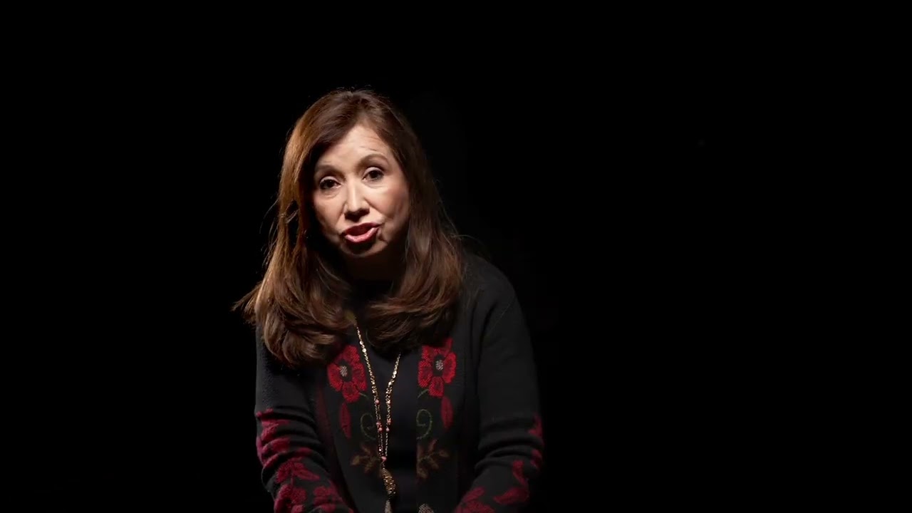 A Latinx woman on a black background