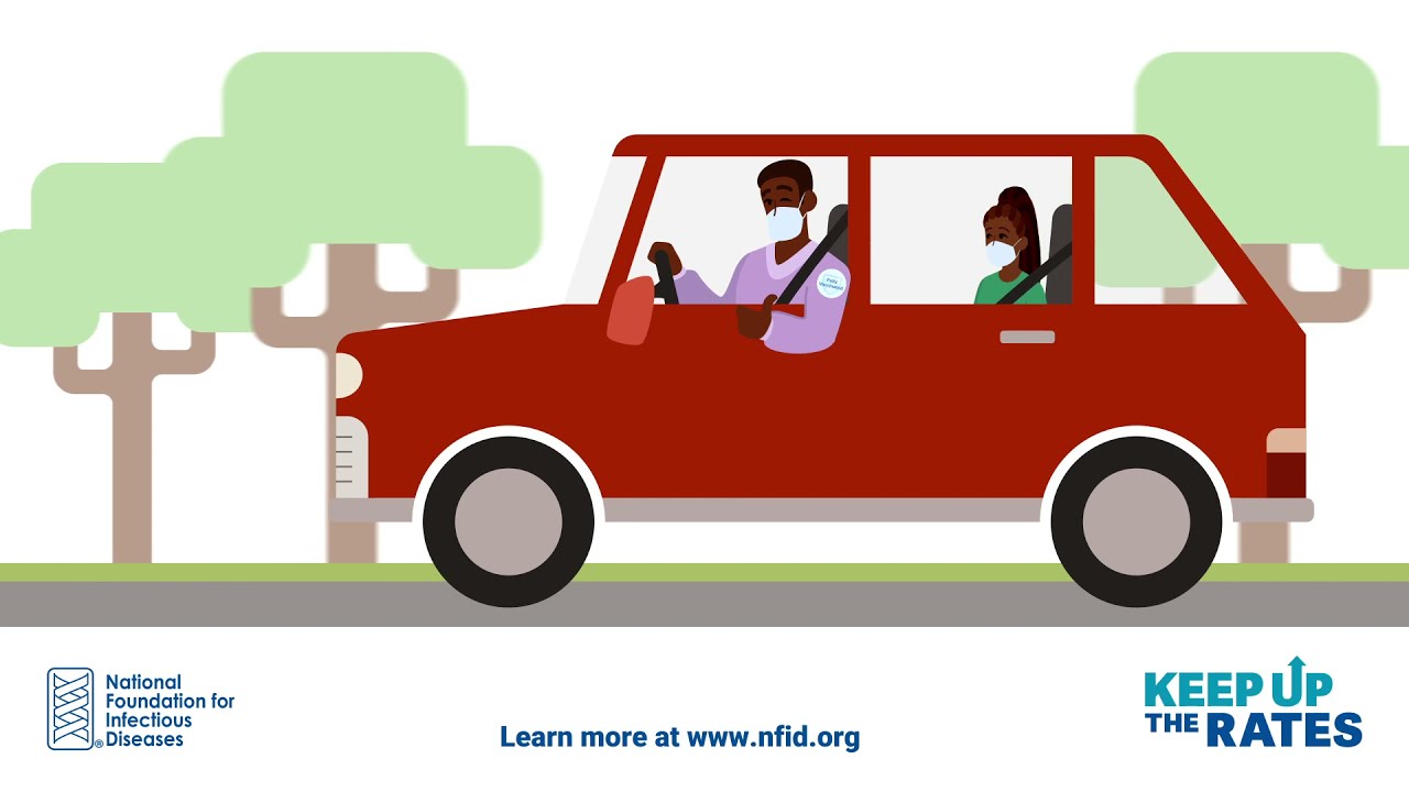 A Black family riding in a red car and wearing masks. 