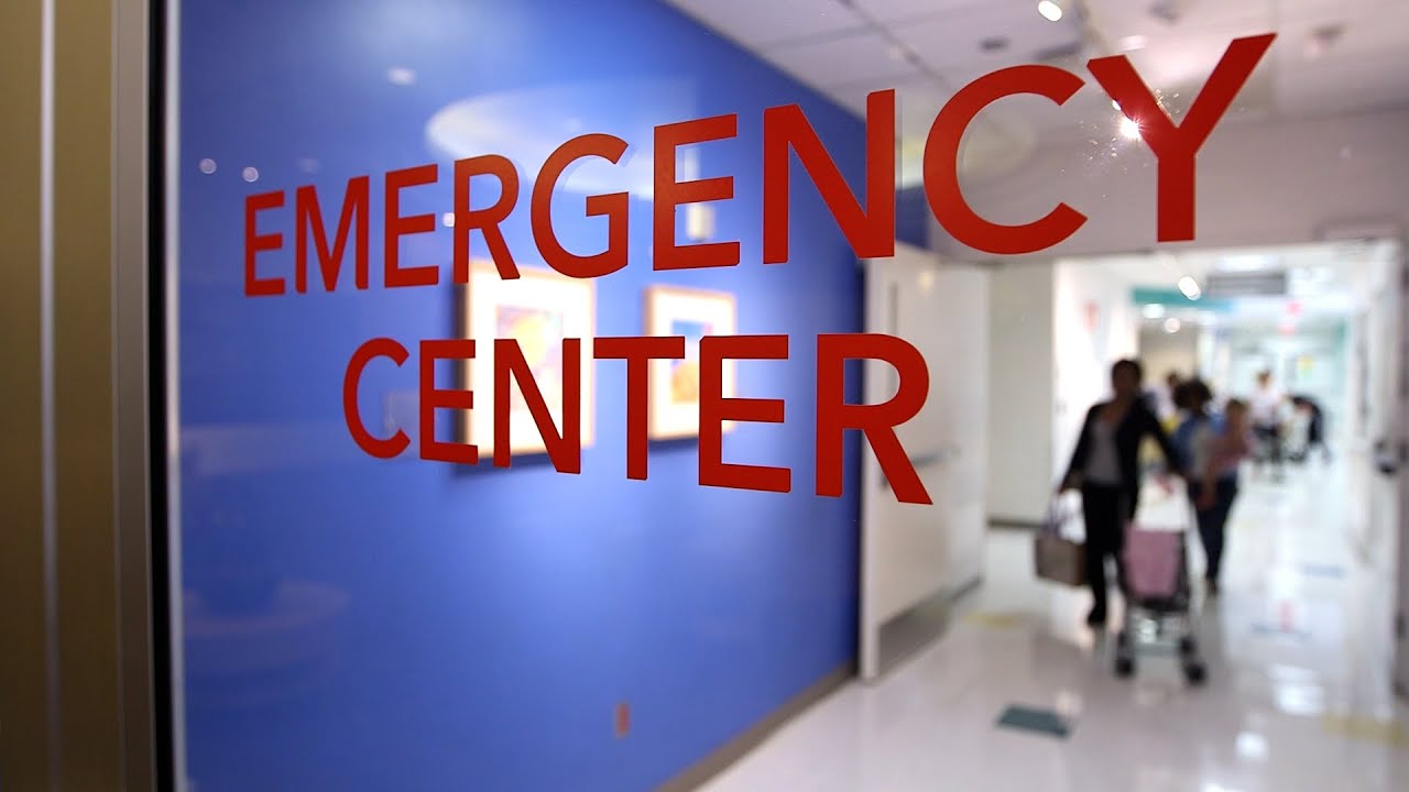 Close up of the words "Emergency Center" on a clear hospital door