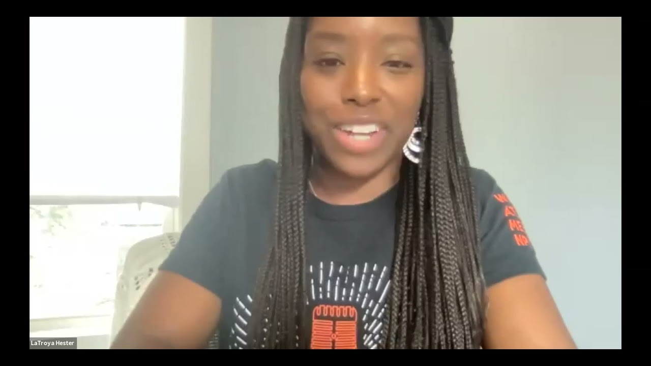 Still image of an African American woman giving a presentation