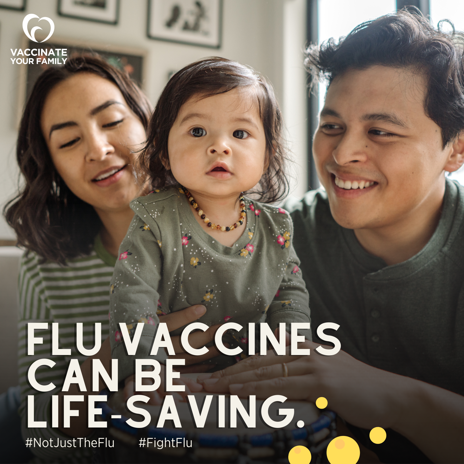 Two parents smile and hold their toddler