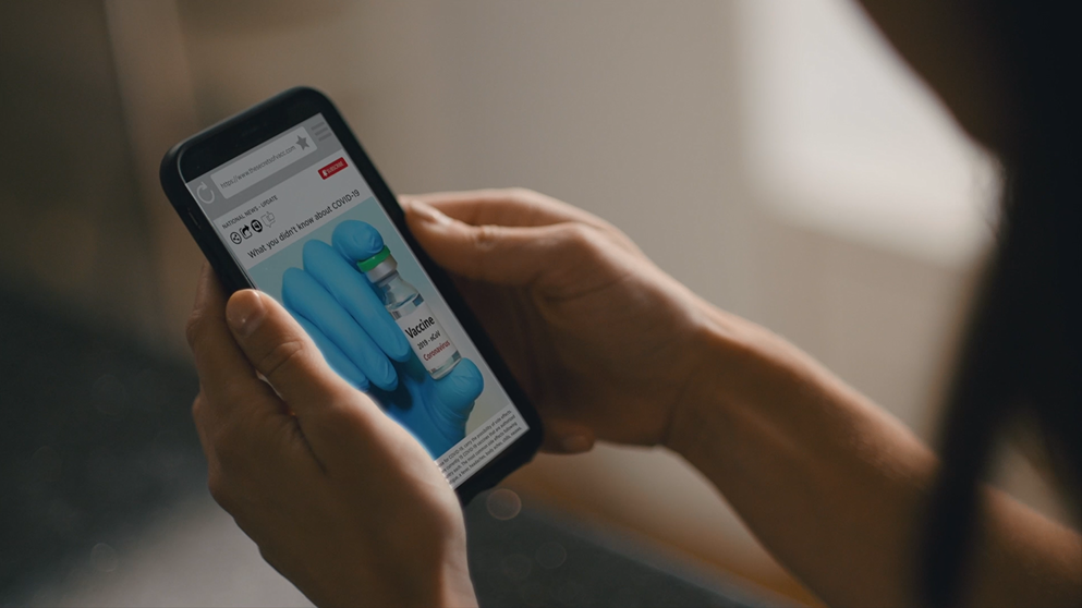 hands holding a phone as though the person is reading the screen