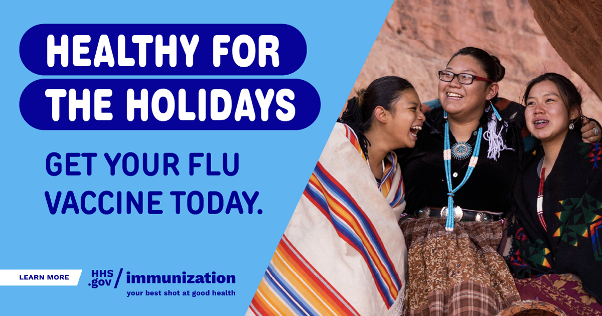 Three Native American women embrace and smile. Text reads, "Healthy for the holidays. Get your flu vaccine today."