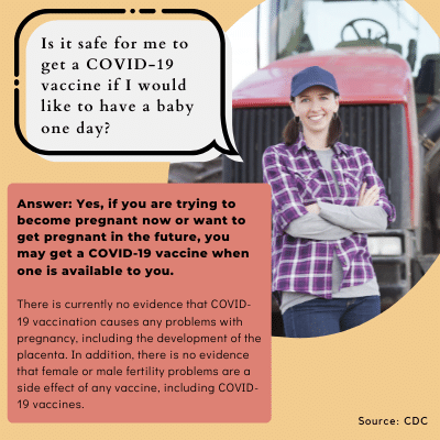 white woman with arms crossed leaning on a tractor