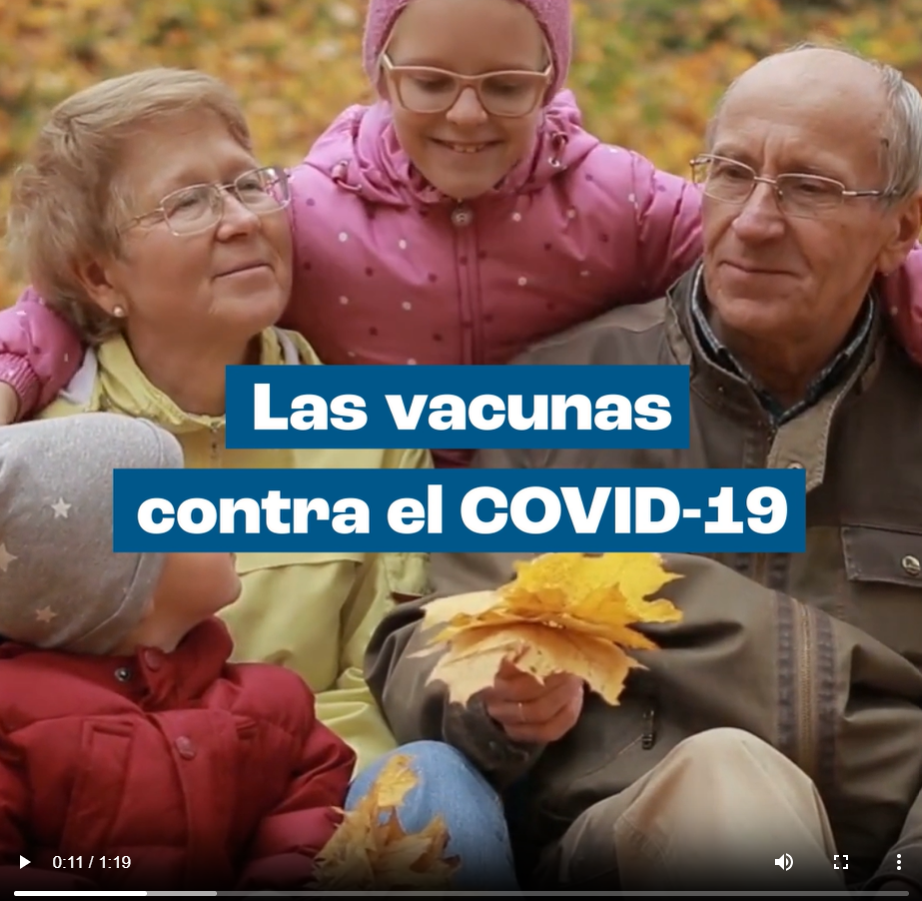 Grandparents sit with their grandchildren outdoors in a fall setting