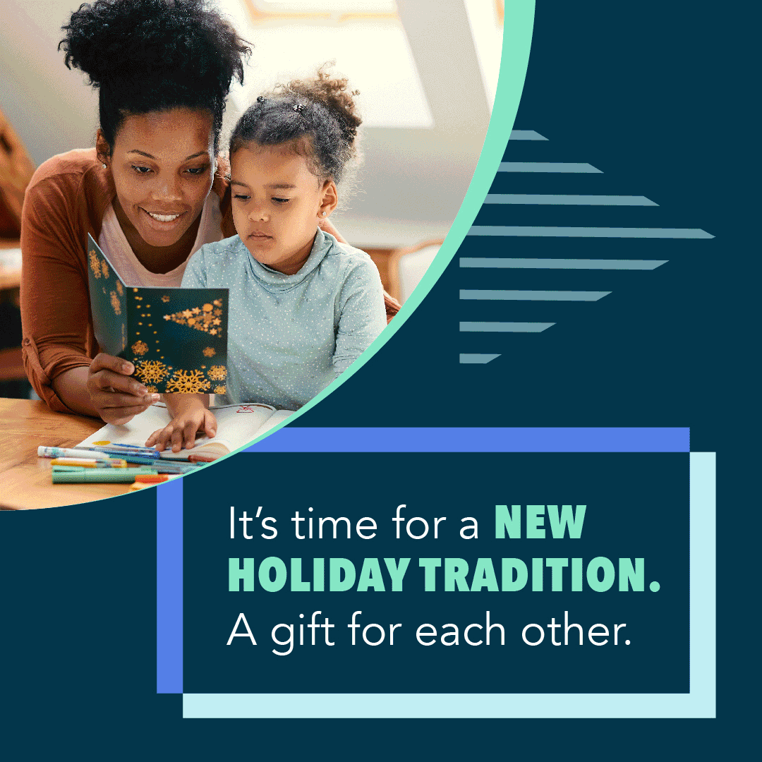 A black woman with her child reading a holiday card