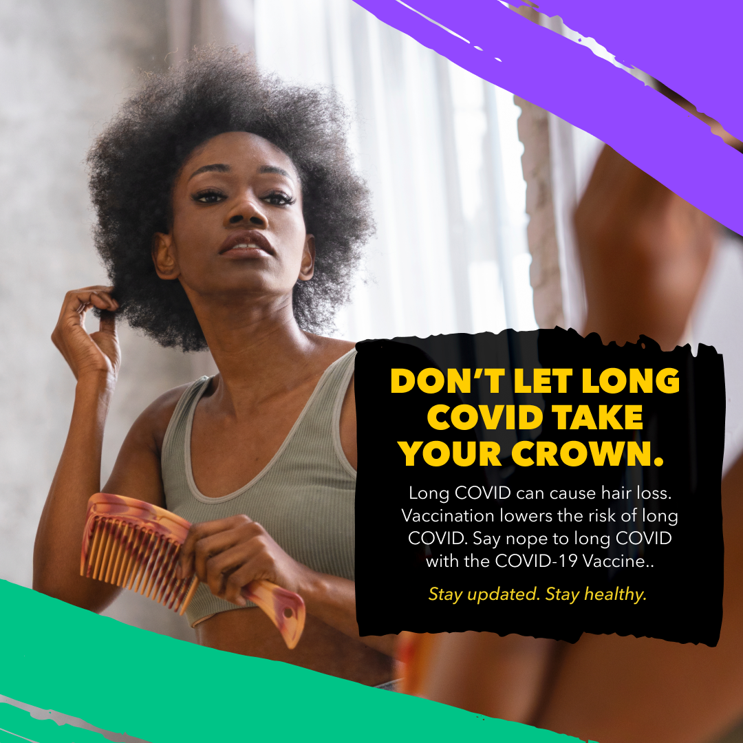 Black woman looks at herself in the mirror with a comb in her hand and touches her hair.