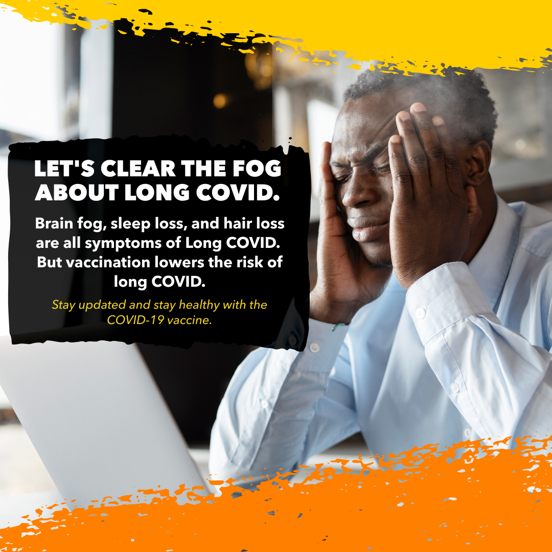 A Black man looks uncomfortable as he rubs his temples.