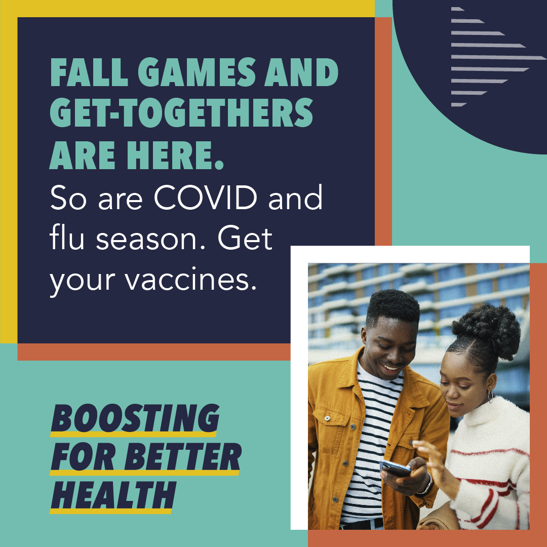 A young Black woman and young Black man smile and look at a phone