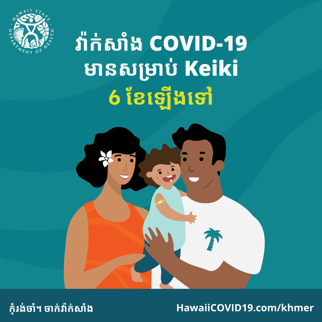 A man and woman smile holding a smiling baby