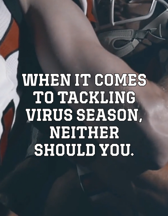 Two football players in full gear tackling each other.