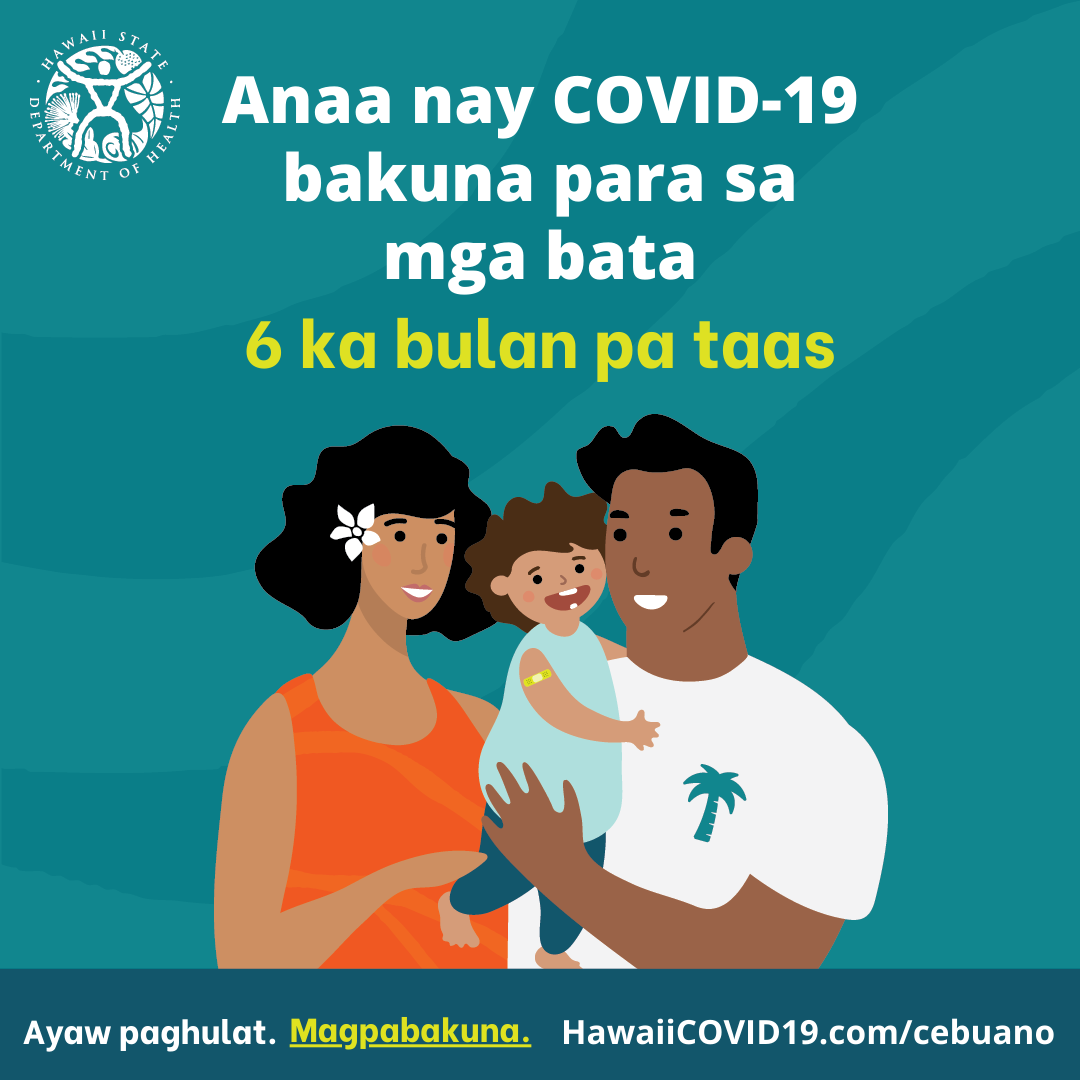 A man and woman smile holding a smiling baby