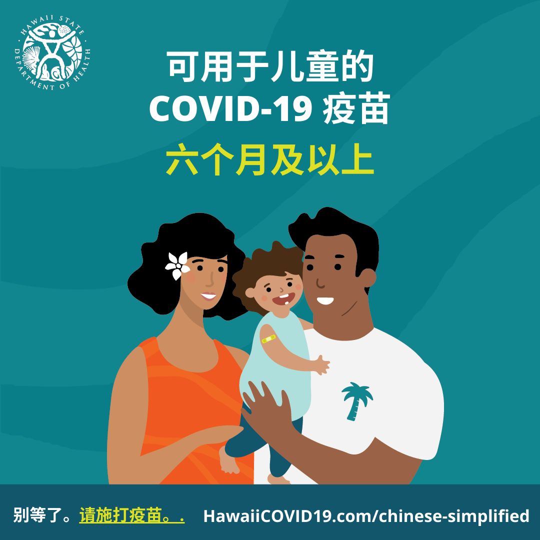 A man and woman smile holding a smiling baby