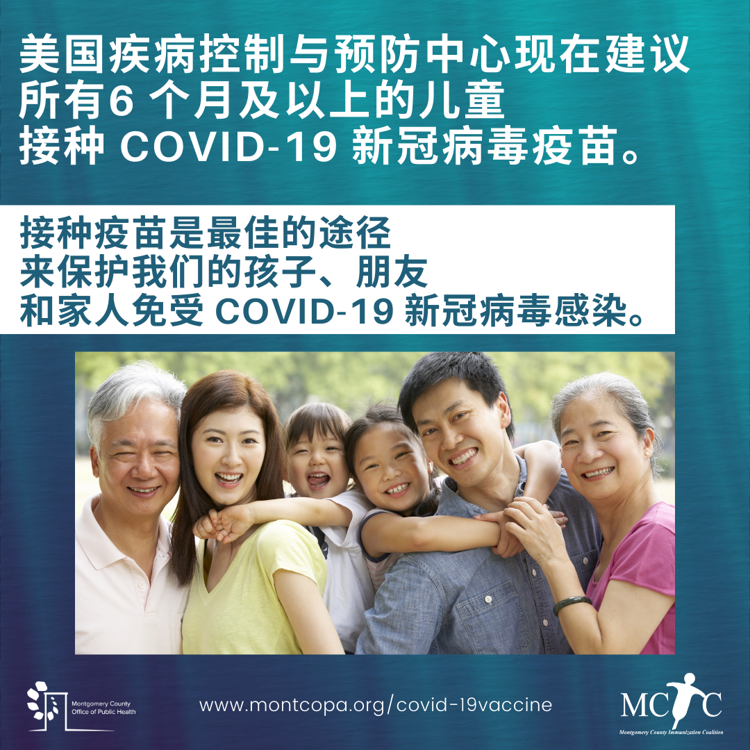 A multigenerational Asian family with two children smiling in a park.