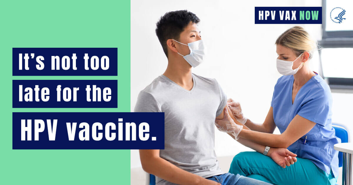 A young Asian man gets ready to receive a vaccine from a white female healthcare worker. Text reads, "It's not too late for the HPV Vaccine. HPV VAX Now."