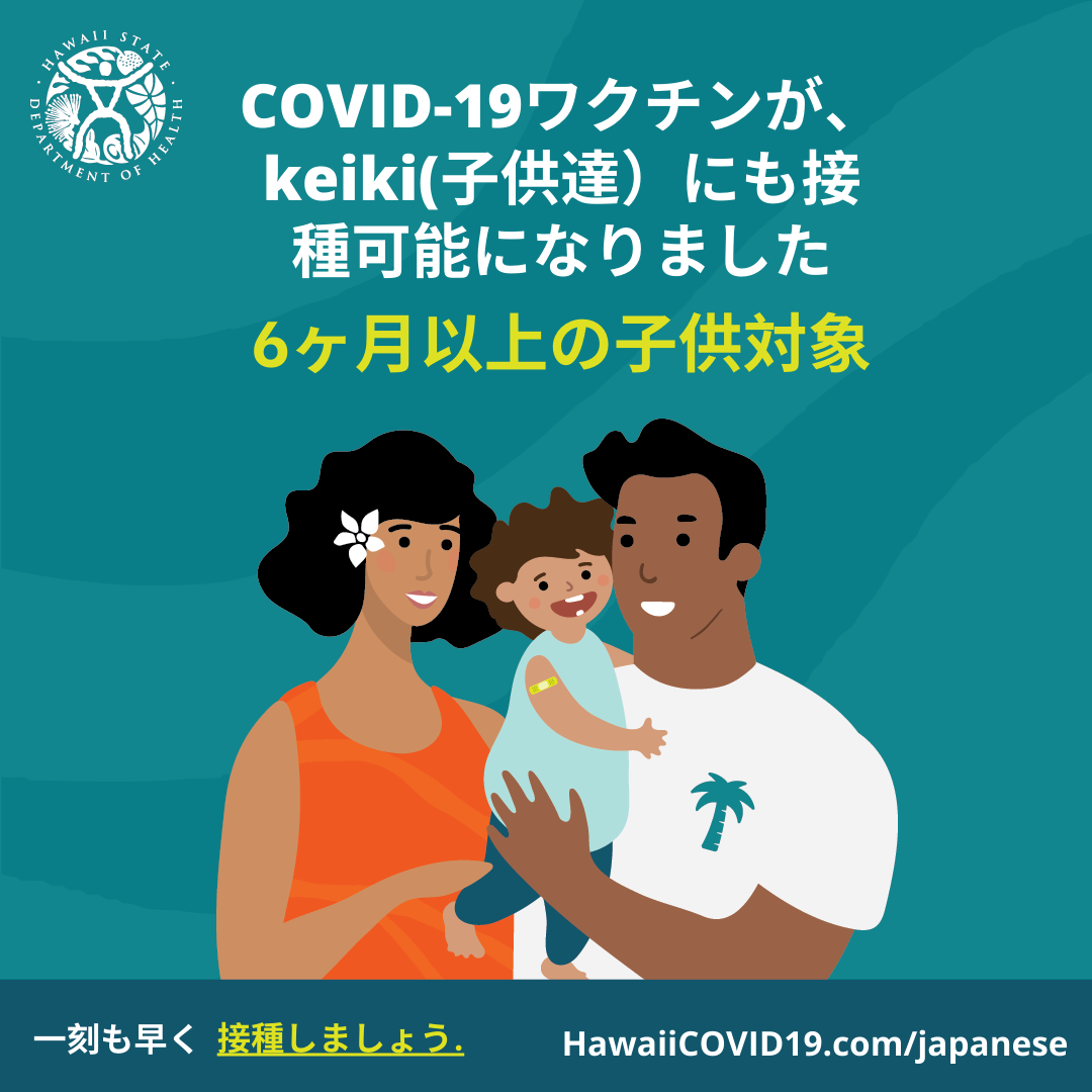 A man and woman smile holding a smiling baby