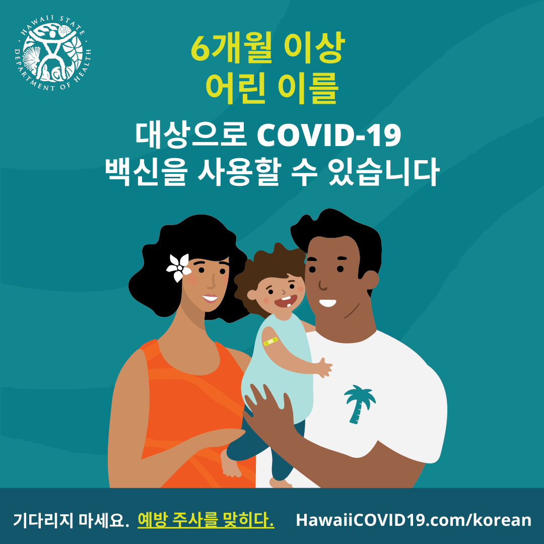 A man and woman smile holding a smiling baby