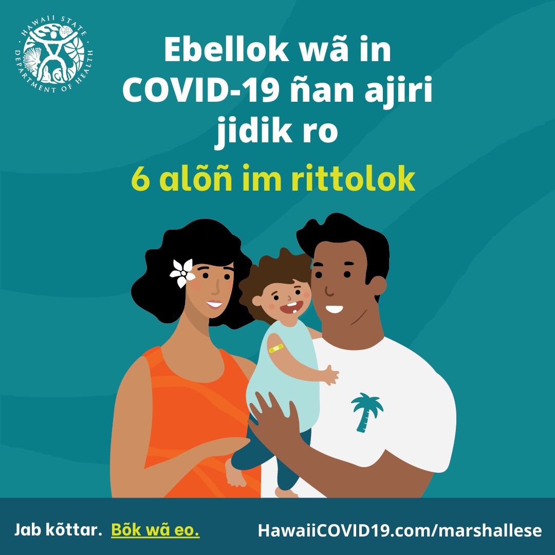 A man and woman smile holding a smiling baby