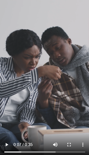 black man and woman looking at a thermometer