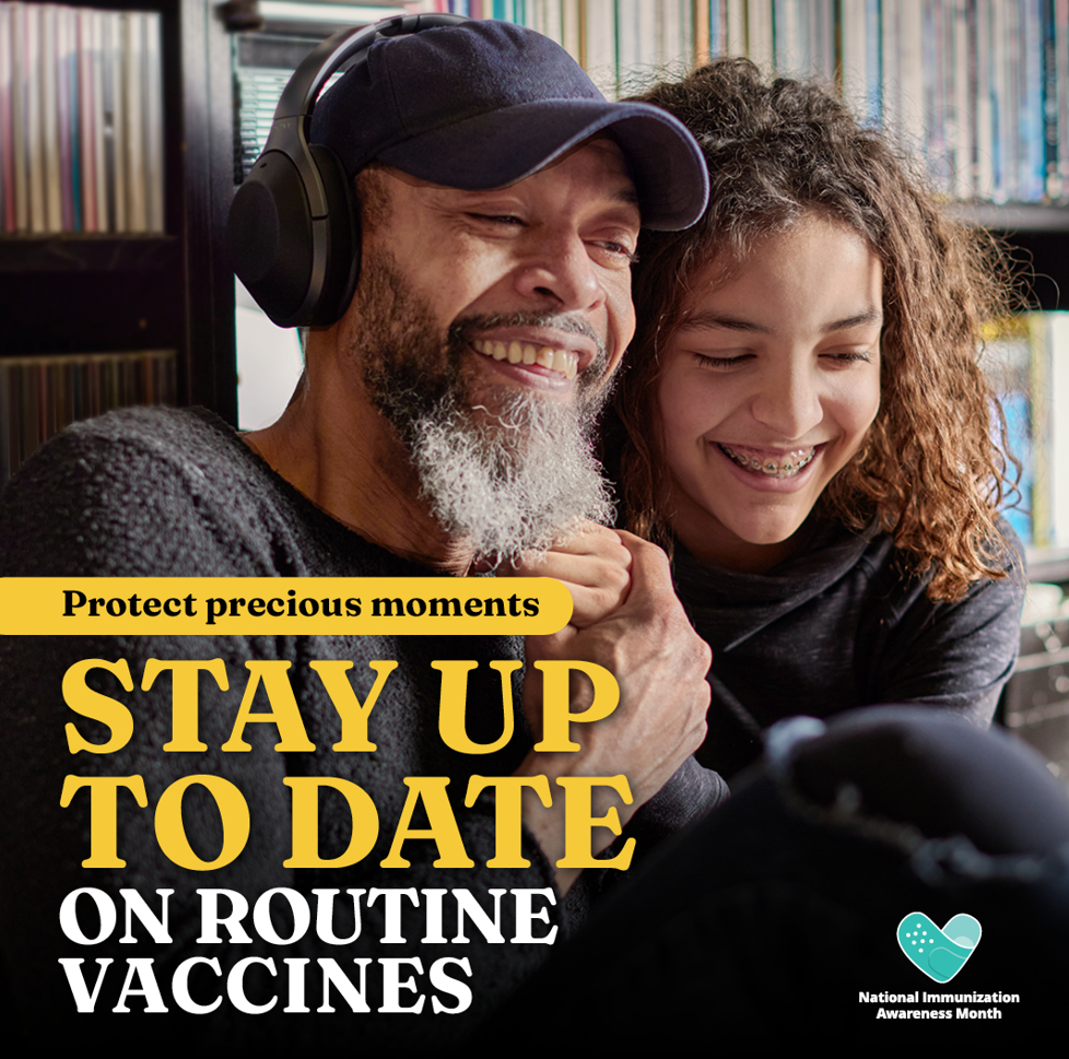 An older Black man wearing headphones smiles and holds hands with a younger Black teenager