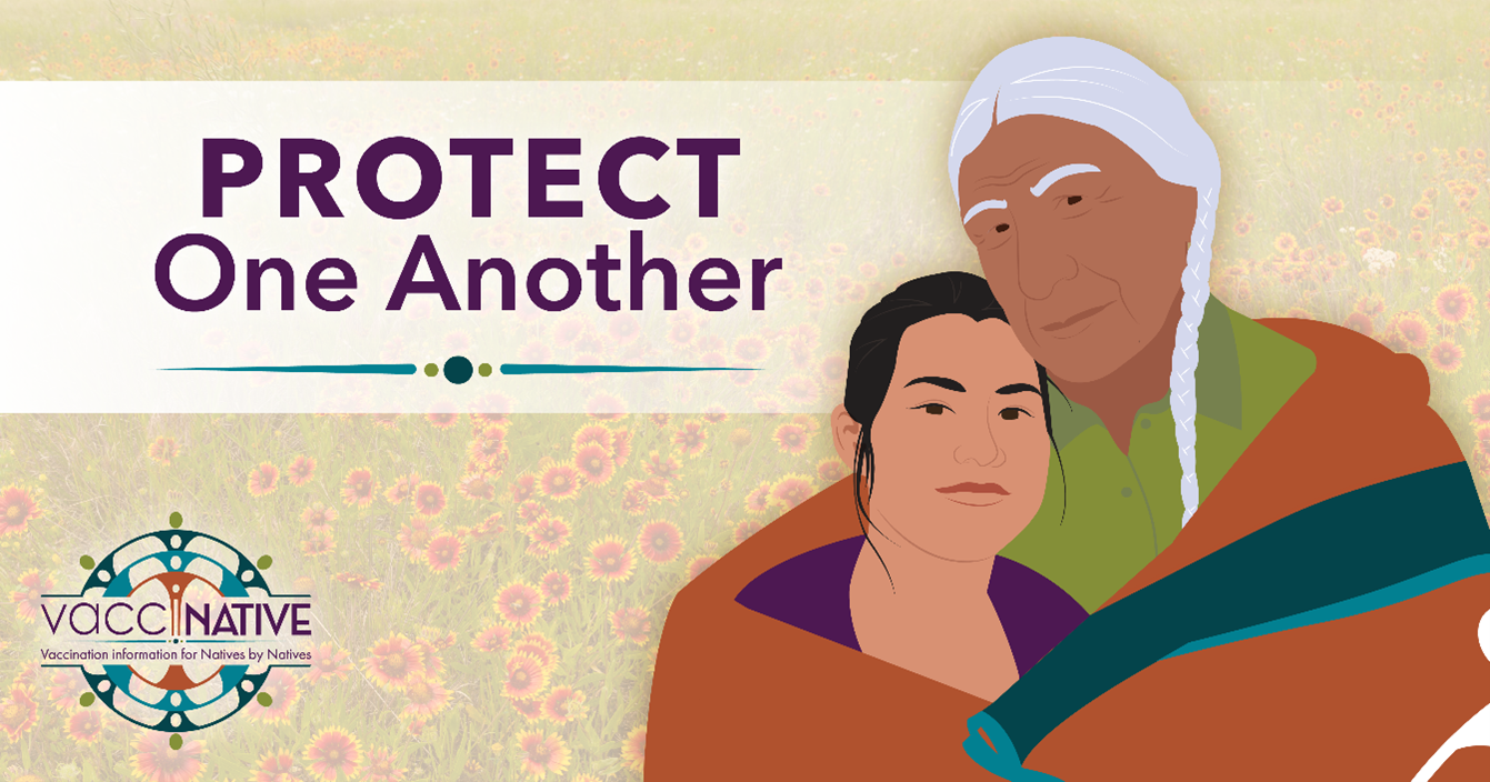 An older Native man embraces a younger Native woman under a quilt.