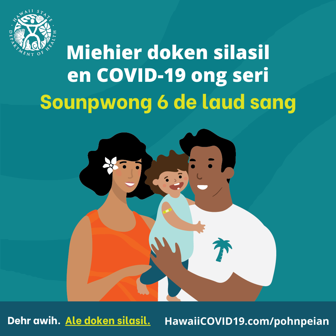 A man and woman smile holding a smiling baby