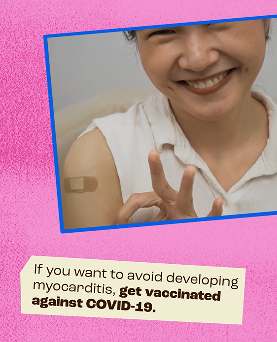 An Asian woman smiles and proudly shows off a band-aid on her shoulder, while touching her thumb and index fingers together to form a circle and indicate approval.
