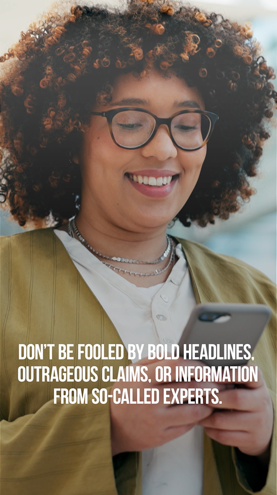 Video still shows a Black woman with glasses smiling and looking at her phone.