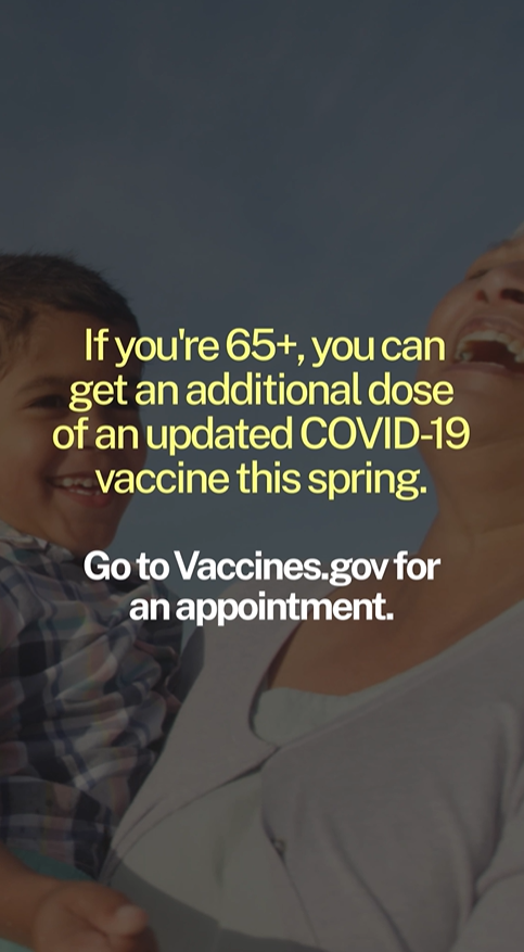 A grandmother laughs and holds her smiling grandchild in her arms.