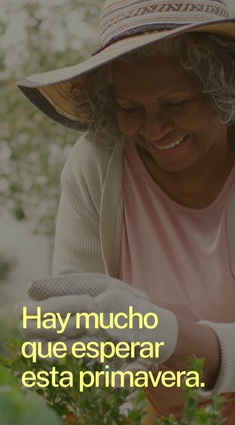 Video still shows an older Black woman wearing a sunhat and gloves, smiling and gardening outside in the sun.