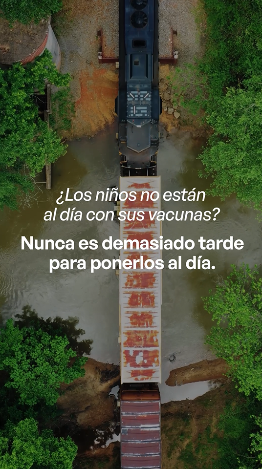 Video still shows an aerial view of a train crossing a riverbed.