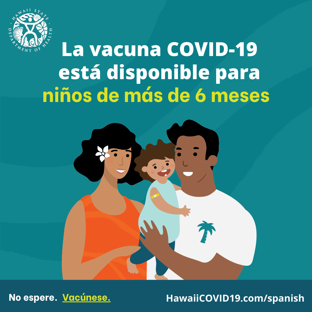 A man and woman smile holding a smiling baby