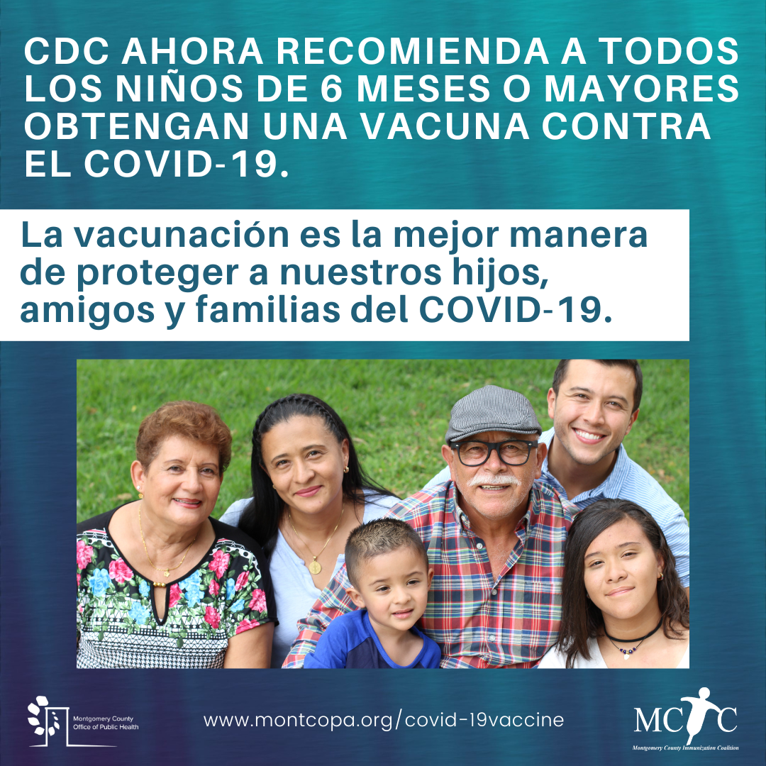 A multigenerational Hispanic family with two children smiling in a park.