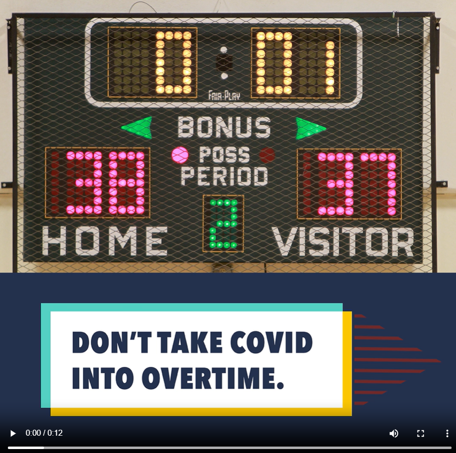 Image shows a scoreboard at a basketball game