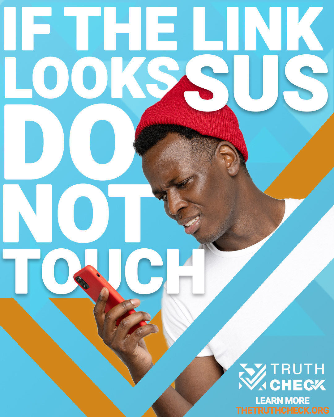 A young Black man wearing a red hat looks at his phone with a quizzical expression