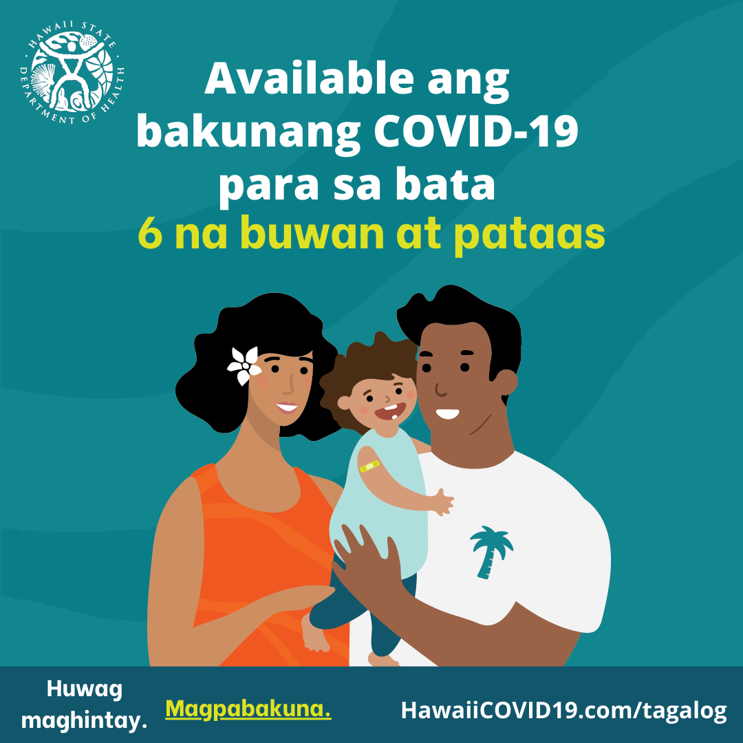 A man and woman smile holding a smiling baby