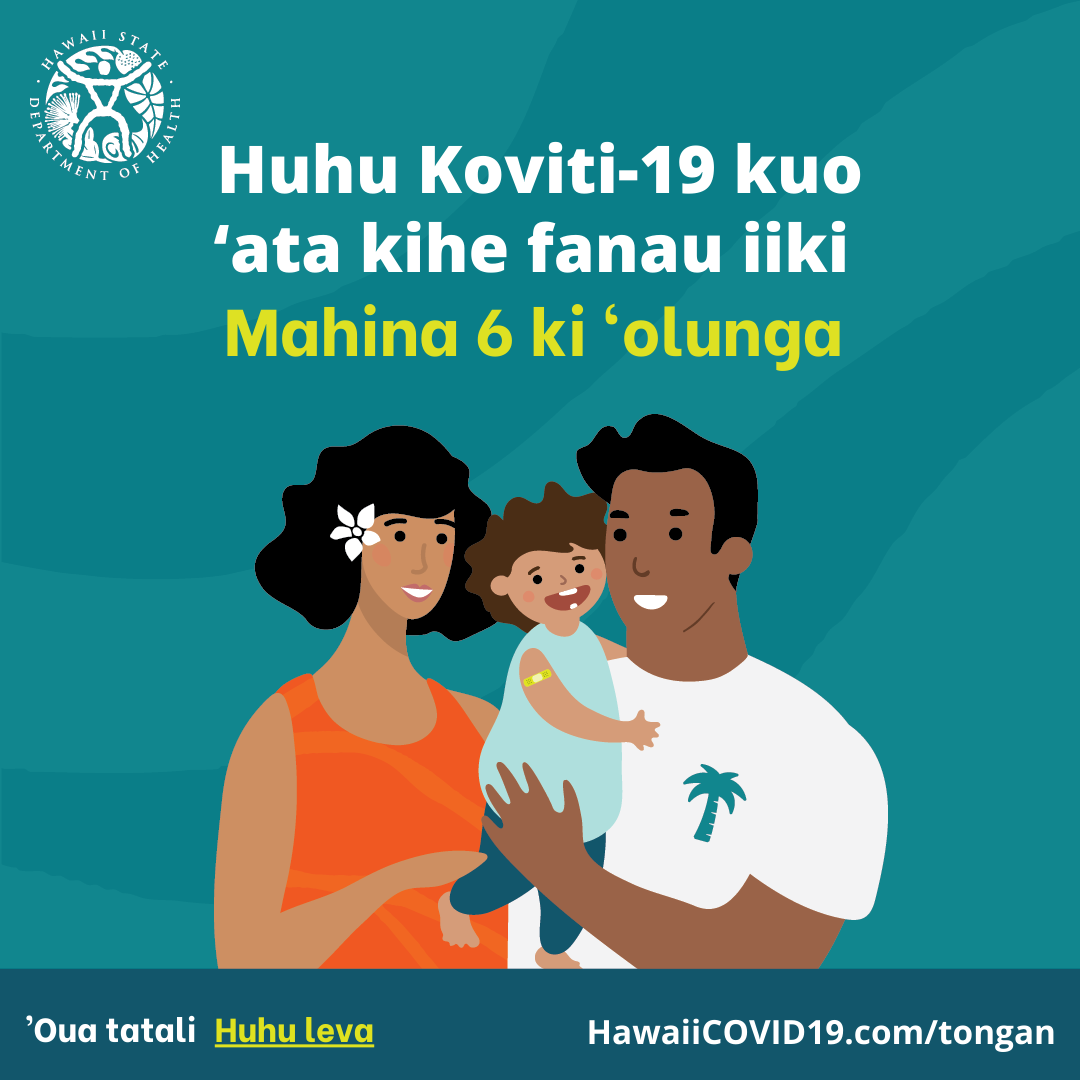 A man and woman smile holding a smiling baby