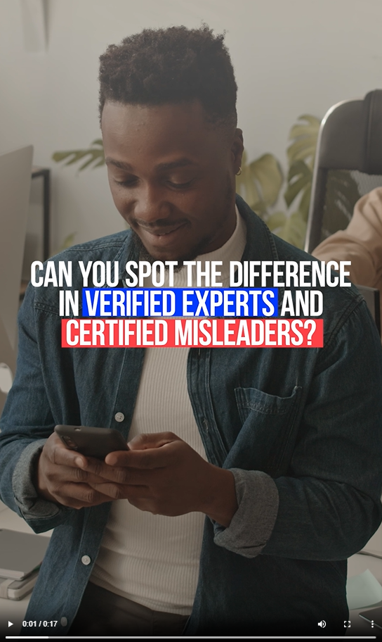 A young Black man smiles and looks at his phone