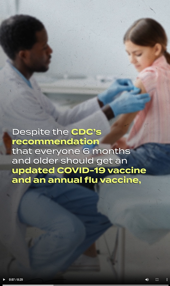 A Black male health care provider puts a band aid on a young girl's shoulder