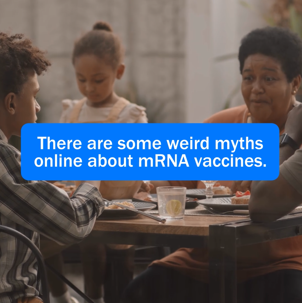 Image of a young black boy, a young black girl, and an older black woman sitting at a table eating a meal together.