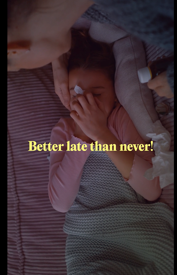 Image of a white girl blowing her nose and her mother caring for her.