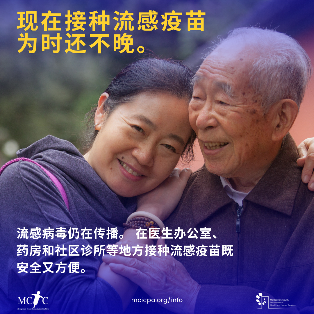 An Asian woman and Asian man embrace and smile