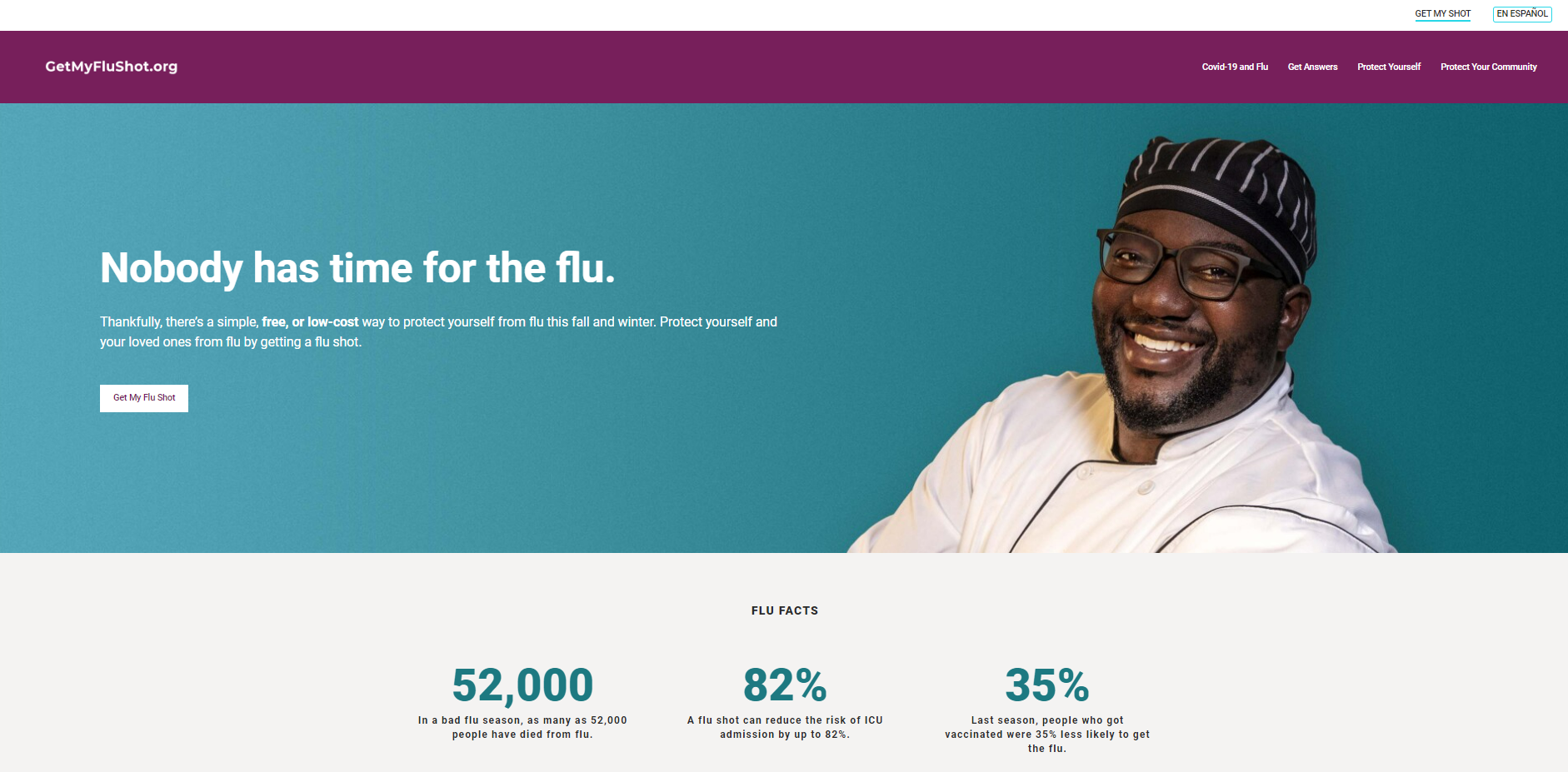 A Black man wearing a white coat and glasses smiles.