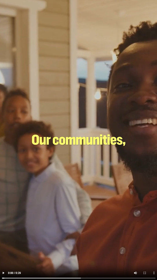 A young Black man and his family pose for a selfie 