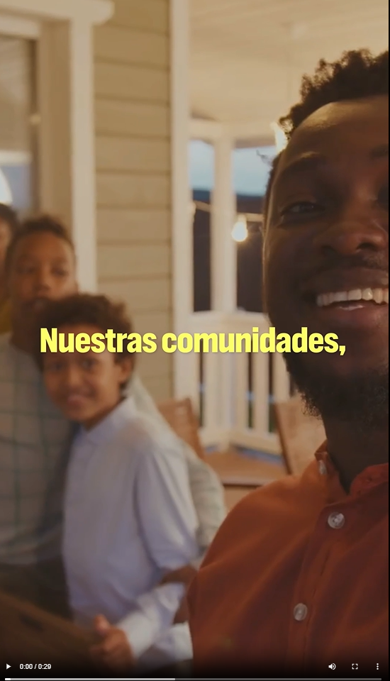 A young Black man and his family pose for a selfie 